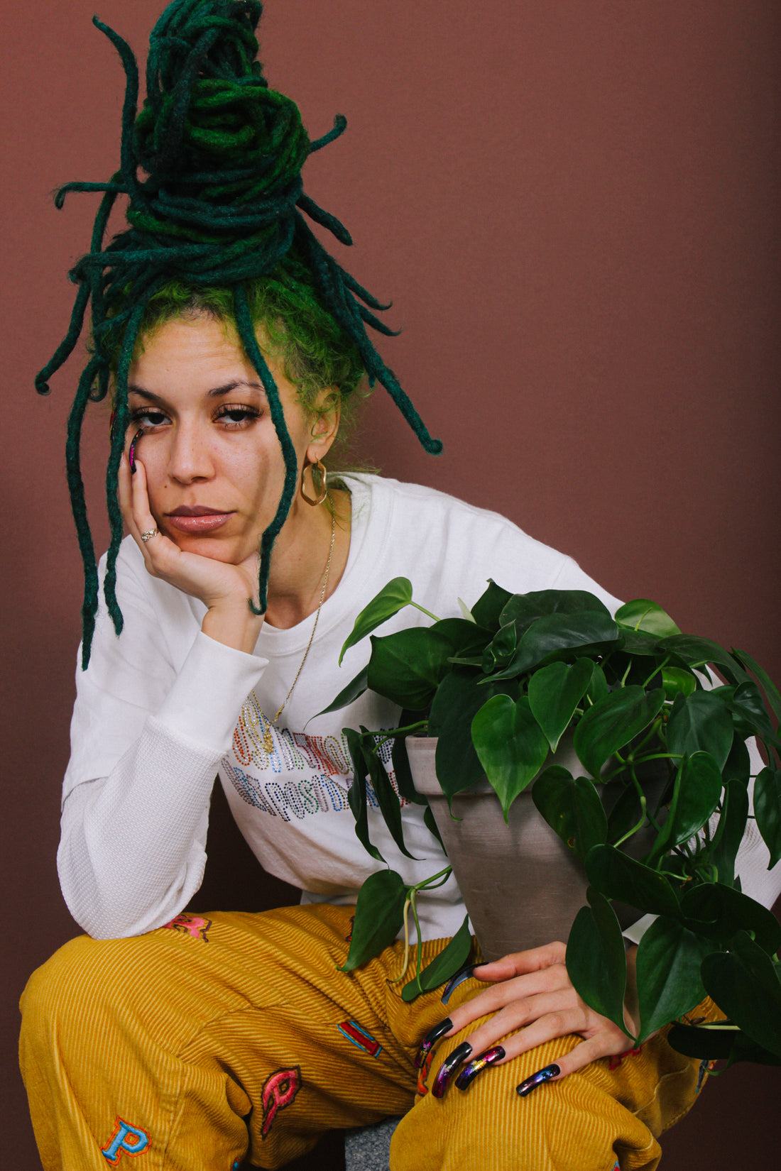 A person holds a plant close on their lap.